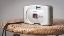 Vivitar IC 101 point-and-shoot camera on woven rattan surface